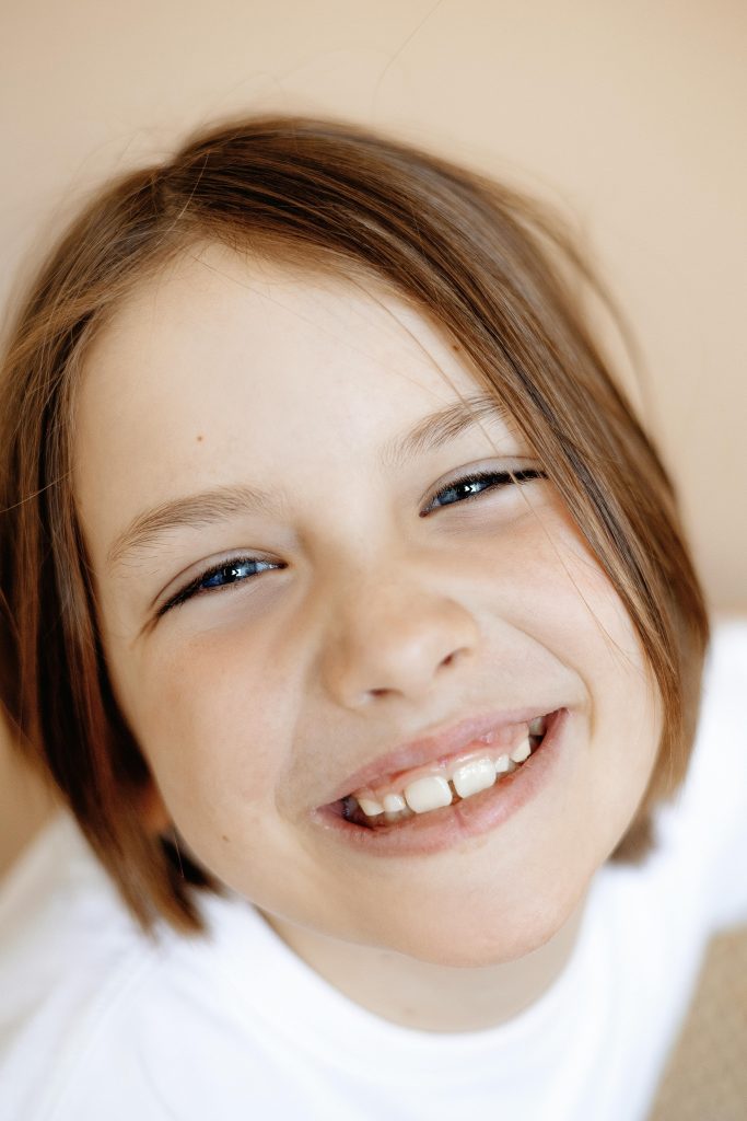 Happy child smiling during a gentle pediatric dentistry appointment