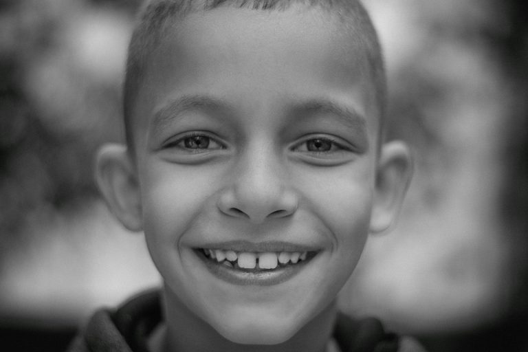 Young child smiling before an emergency pediatric dental visit for urgent dental care